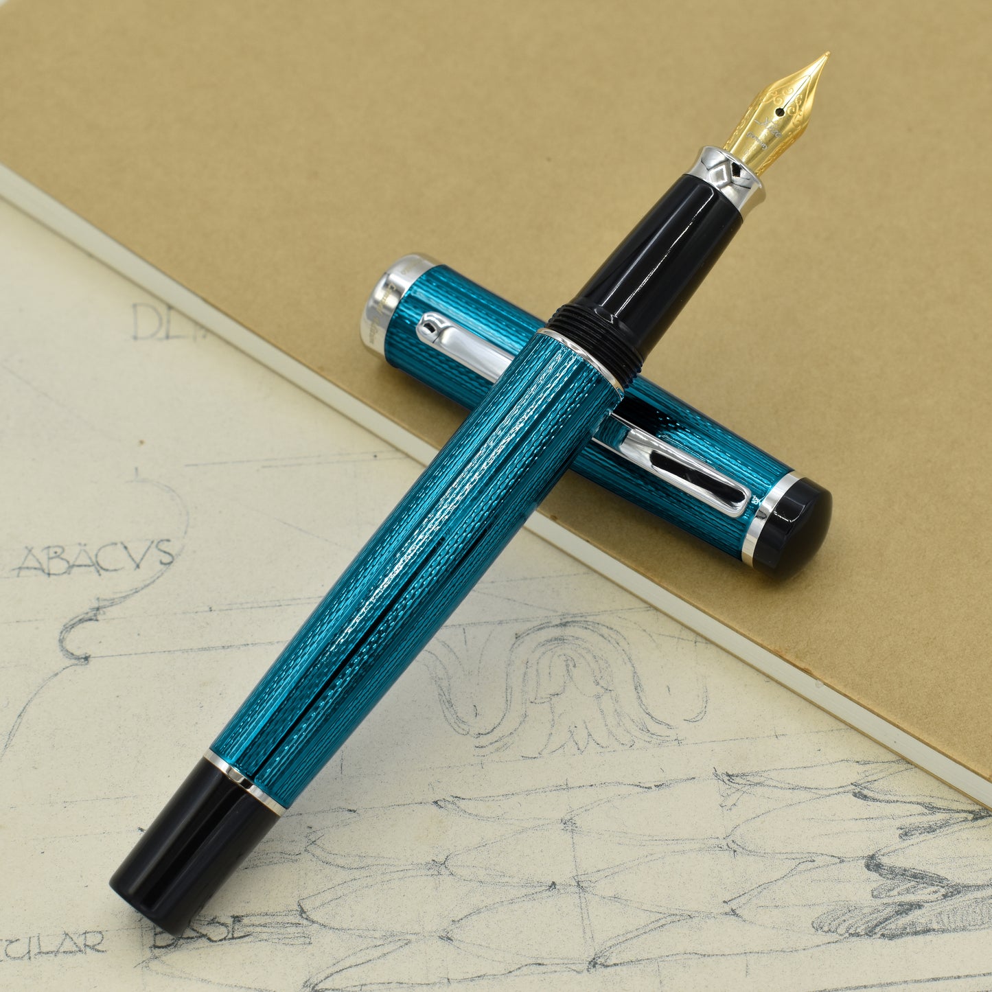 Incognito Blue F-1 Fountain pen with antique architectural sketches and a notebook