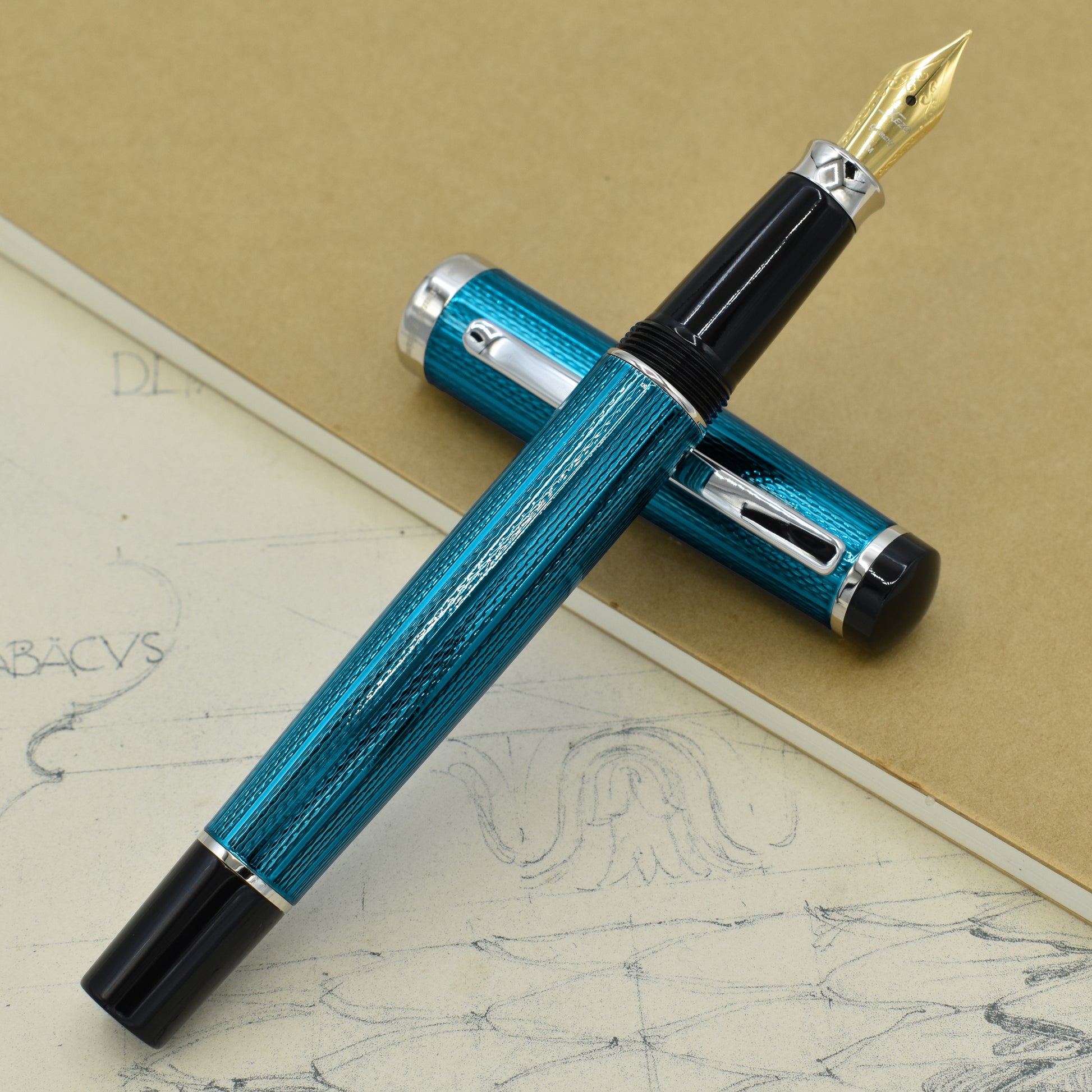 Incognito Blue FM Fountain pen with antique architectural sketches and a notebook