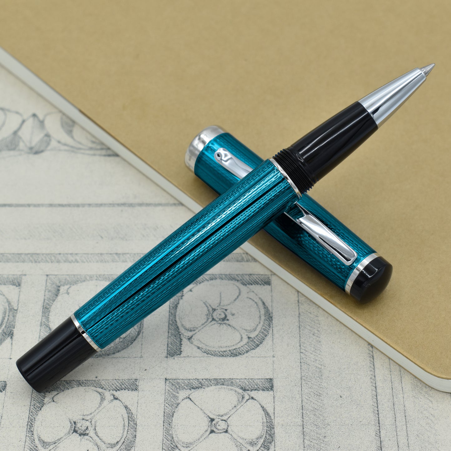 Incognito Blue R-1 Rollerball pen with antique architectural sketches and a notebook
