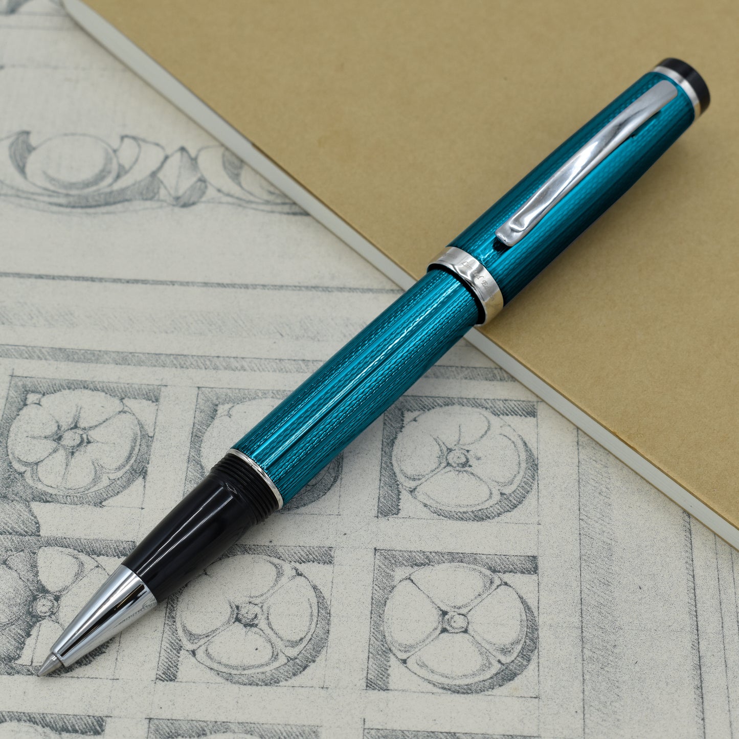 Incognito Blue R-1 Rollerball pen with antique architectural sketches and a notebook