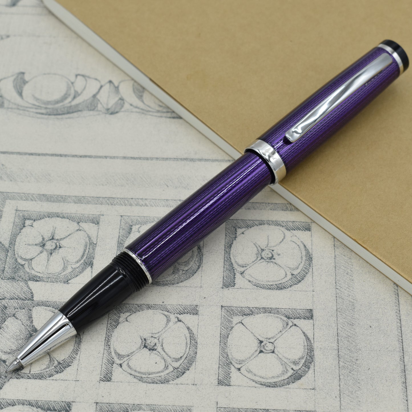 Incognito Purple R Rollerball pen with antique architectural sketches and a notebook