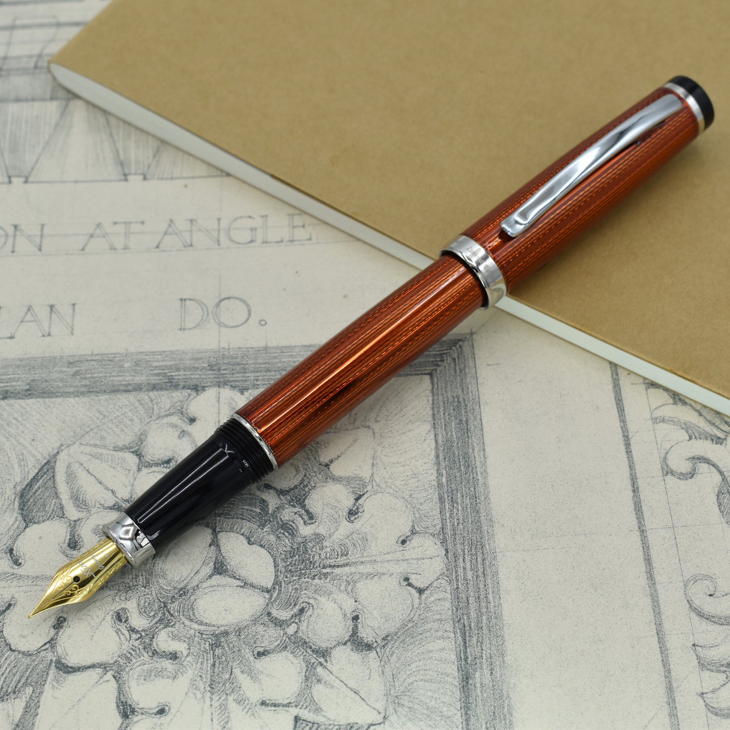 Incognito Sunstone F Fountain pen with antique architectural sketches and a notebook