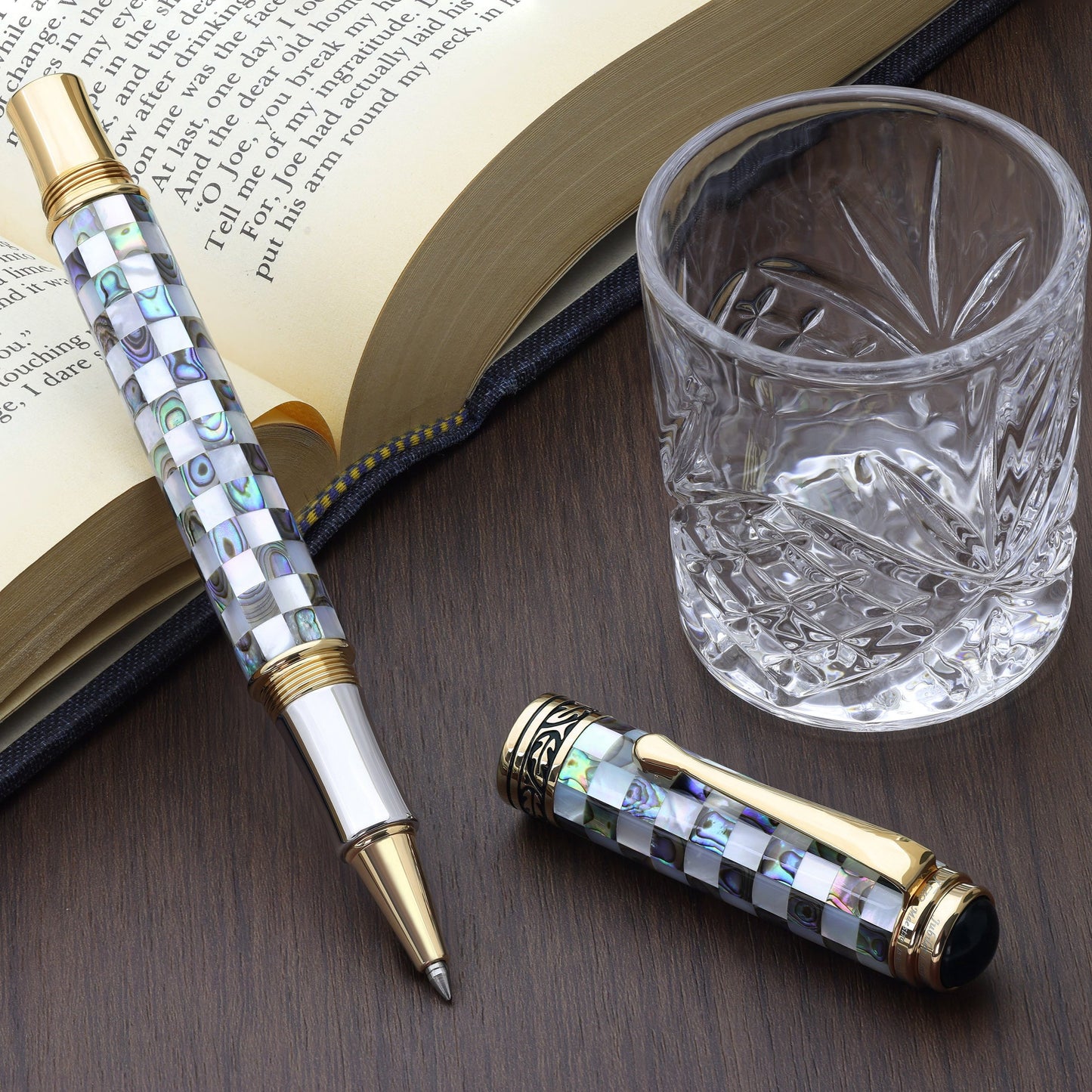 Maestro Jubilee Classic Of The Ocean R Rollerball pen with a book and glass cup