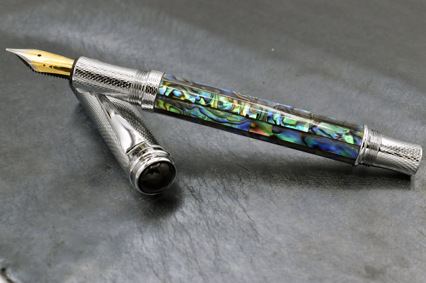Maestro Paua Abalone Chrome F Fountain pen on a dark background