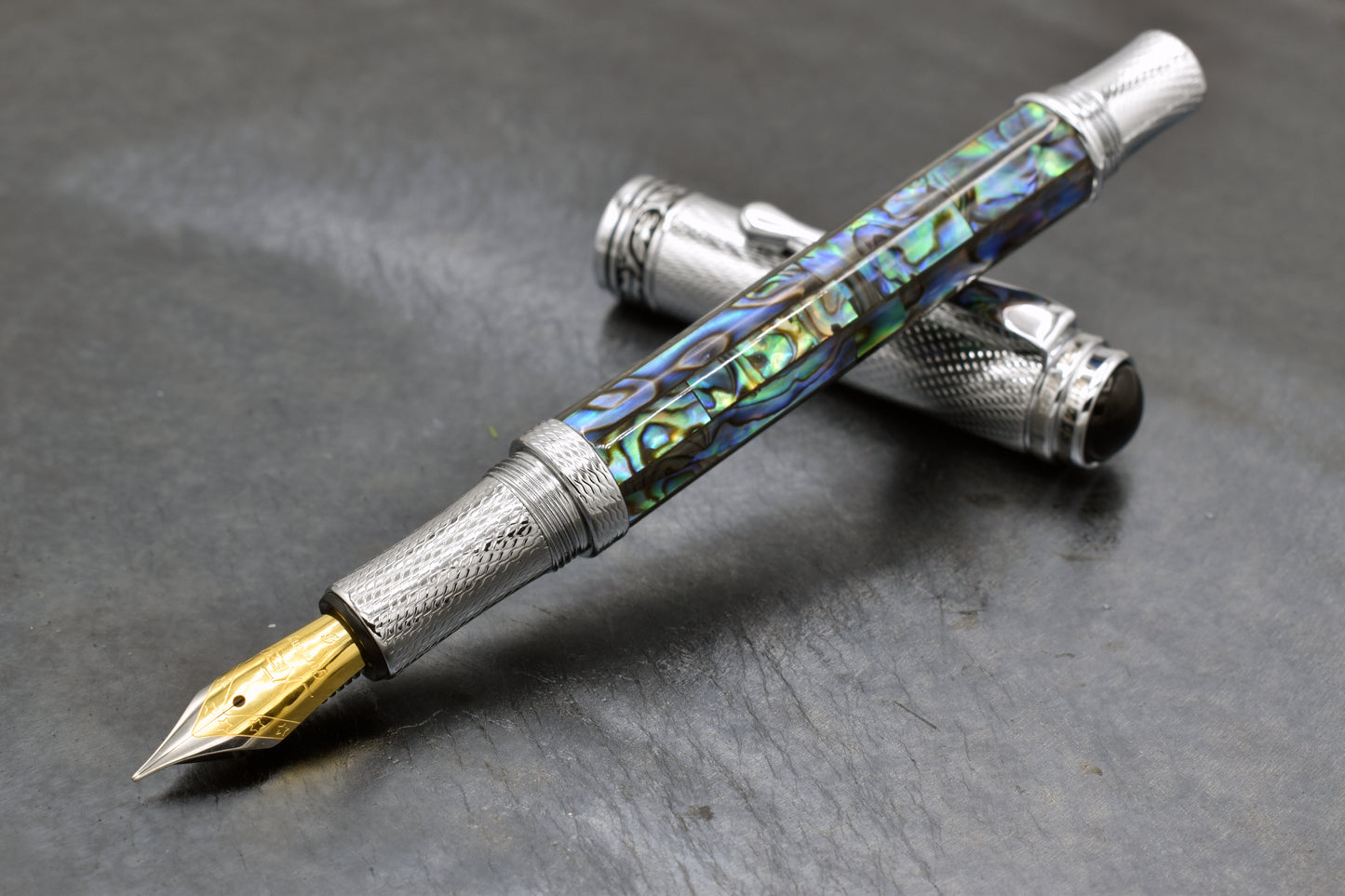 Maestro Paua Abalone Chrome F Fountain pen on a dark background