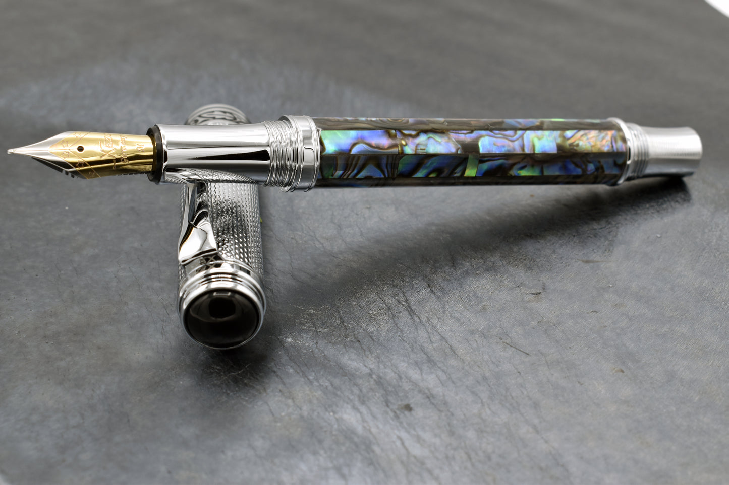 Maestro Paua Abalone Chrome FM Fountain pen on a dark background