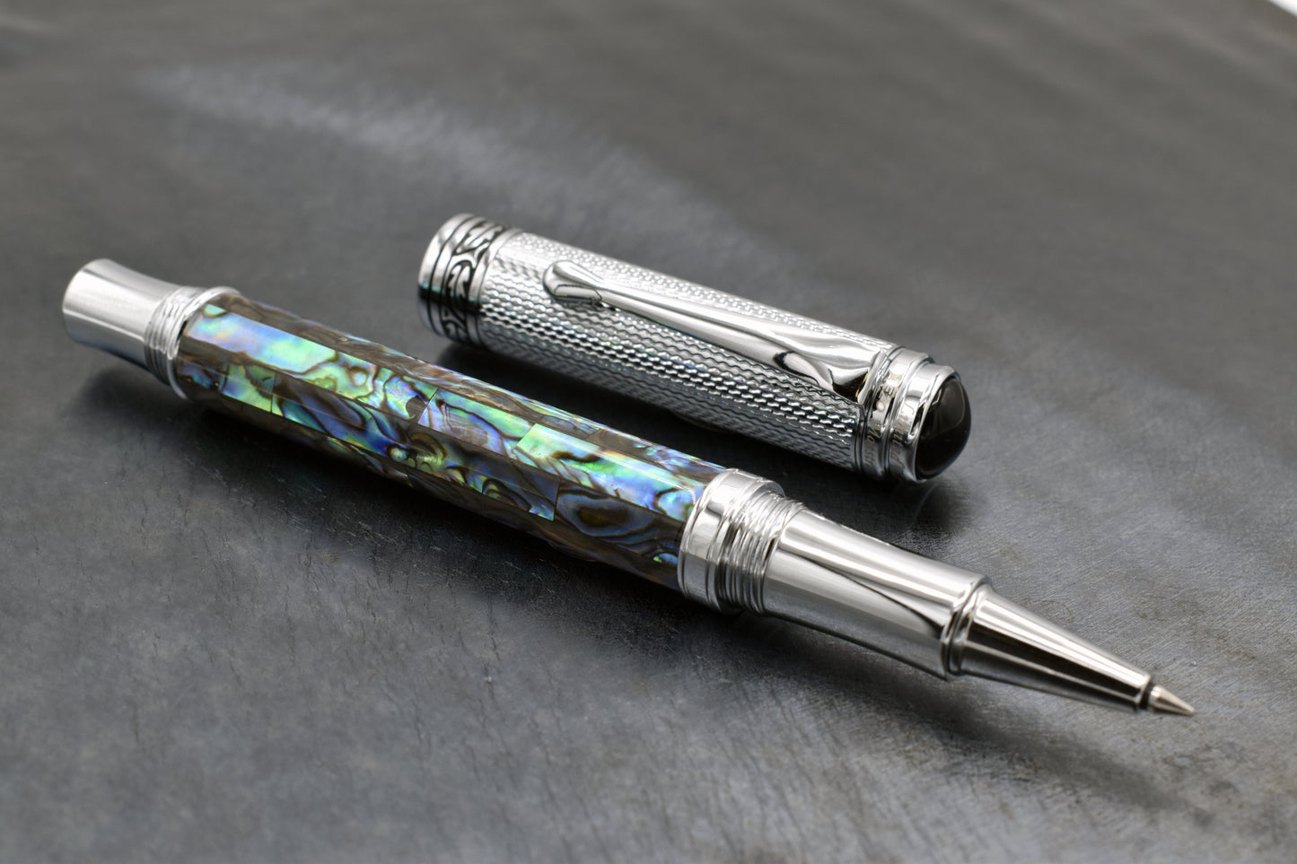 Maestro Paua Abalone Chrome R Rollerball pen on a dark background