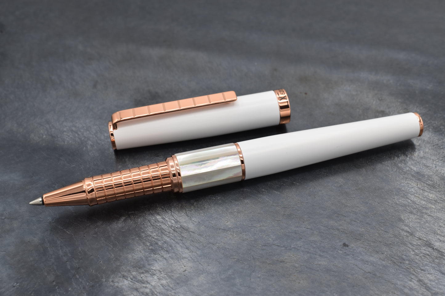 Speed Master White R-WRG Rollerball pen on a dark background
