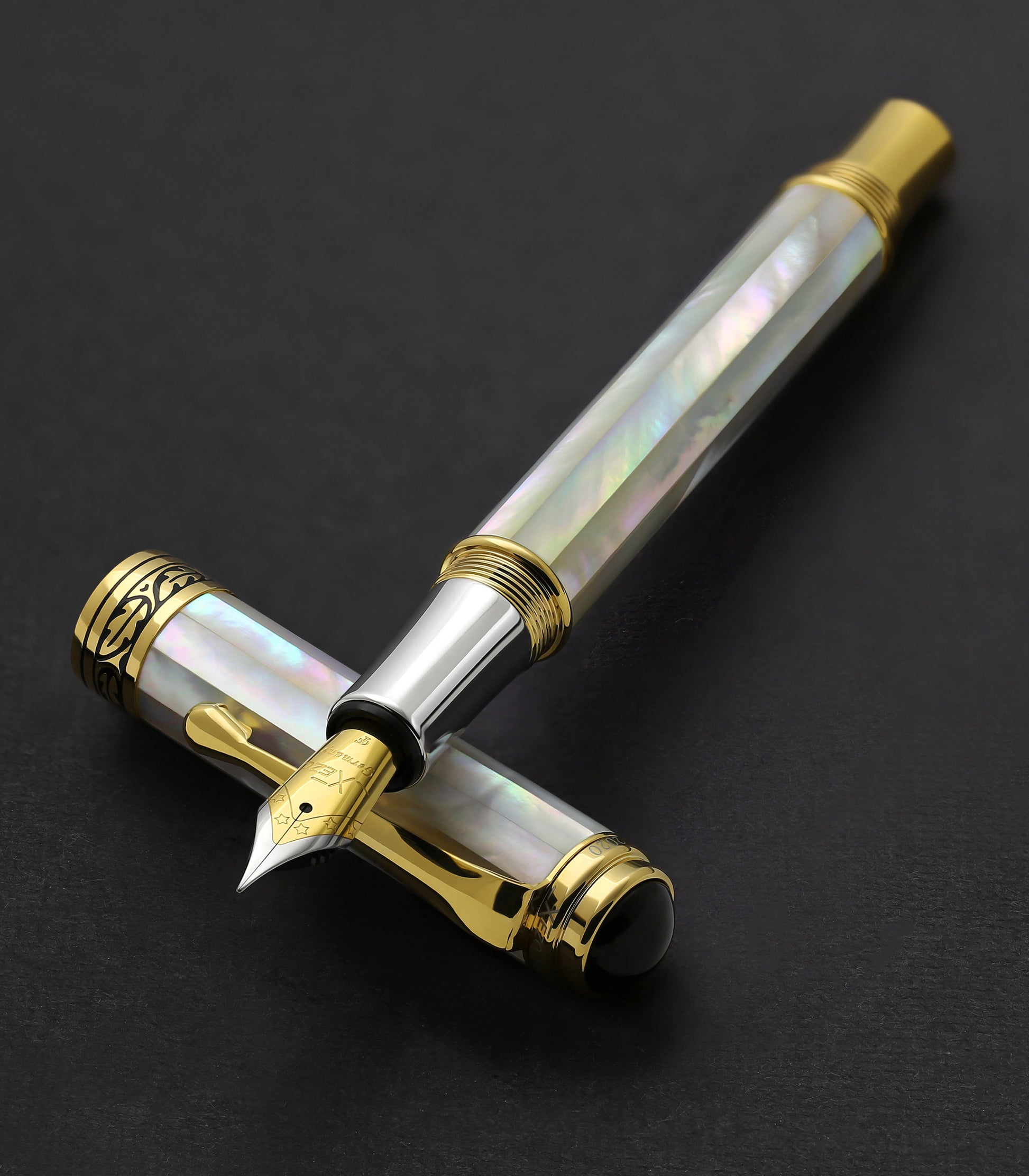 Maestro White MOP F fountain pen resting on its cap
