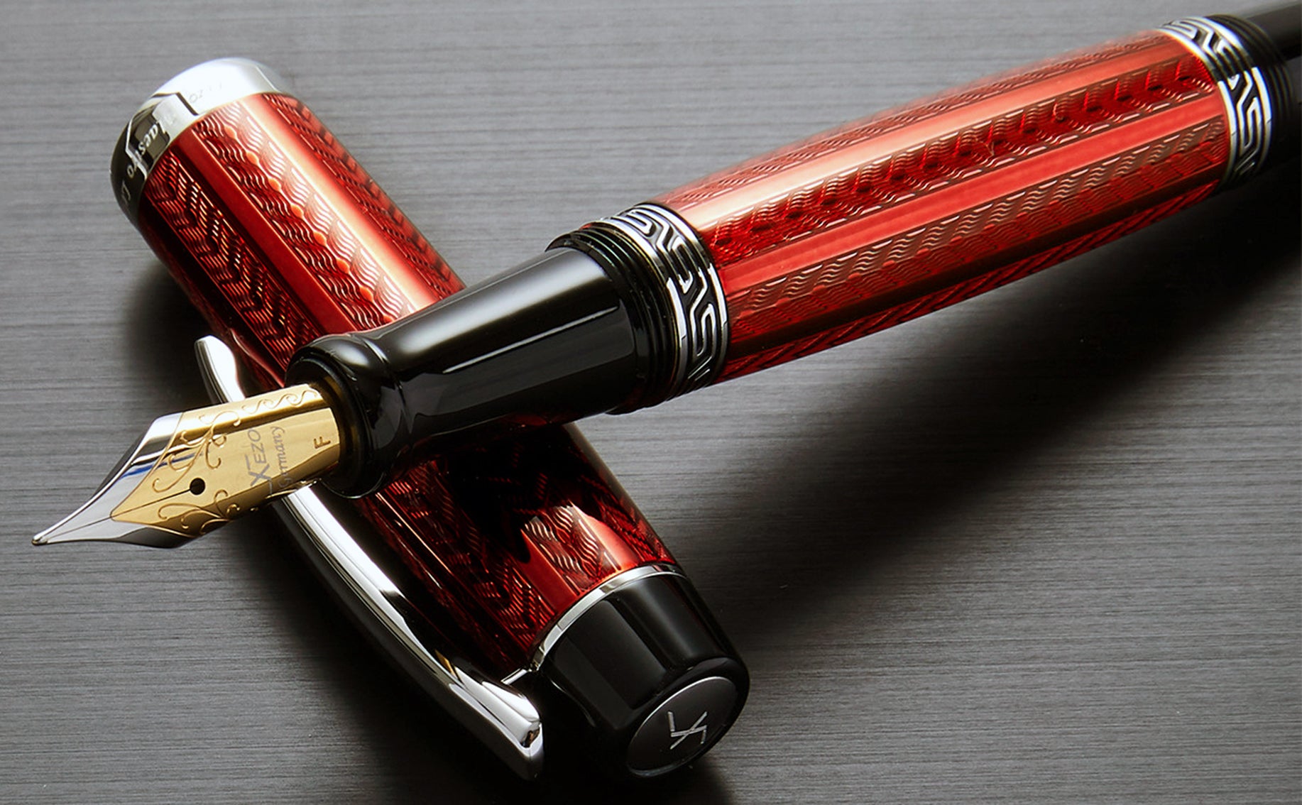 Xezo - Maestro LeGrand Rhodochrosite F fountain pen resting on its cap