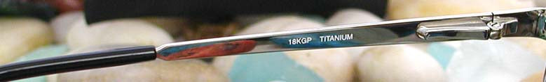 Xezo - Left temple of a pair of Airman 5200 sunglasses from inside. The print of the temple reads "18KGP TITANIUM".