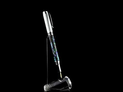 Xezo - A Maestro Paua Abalone Chrome F Fountain pen standing on a turning pen stand