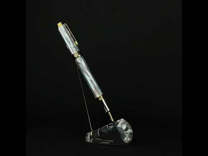 A Maestro White MOP fountain pen standing on a turning pen stand