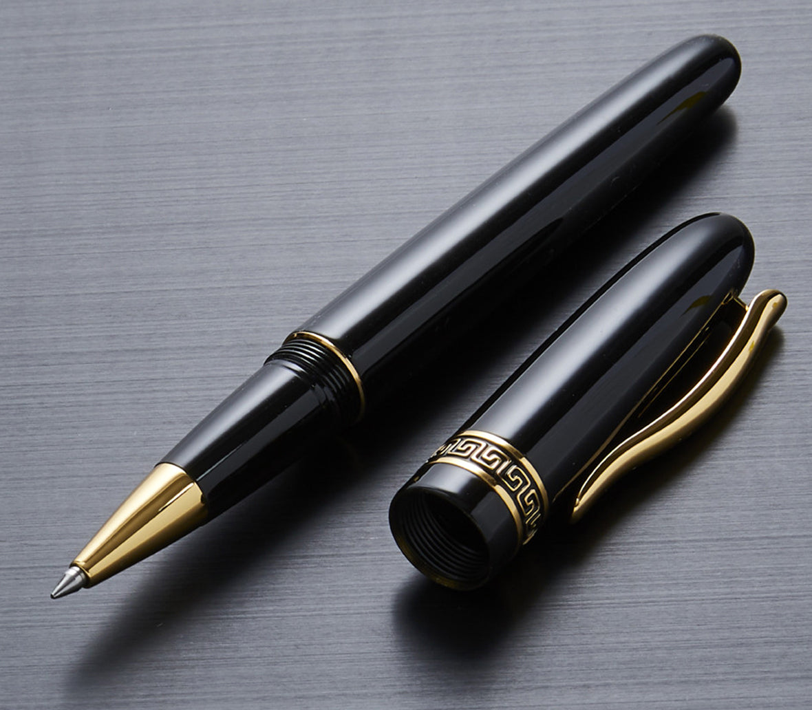 Xezo - Uncapped Phantom Classic Black R rollerball pen with its cap resting next to it