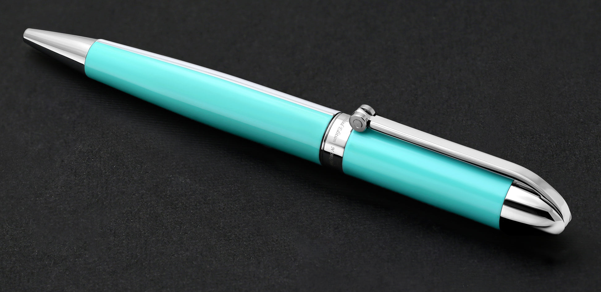 Xezo - Visionary Sky Blue/White B Ballpoint pen resting on a dark background