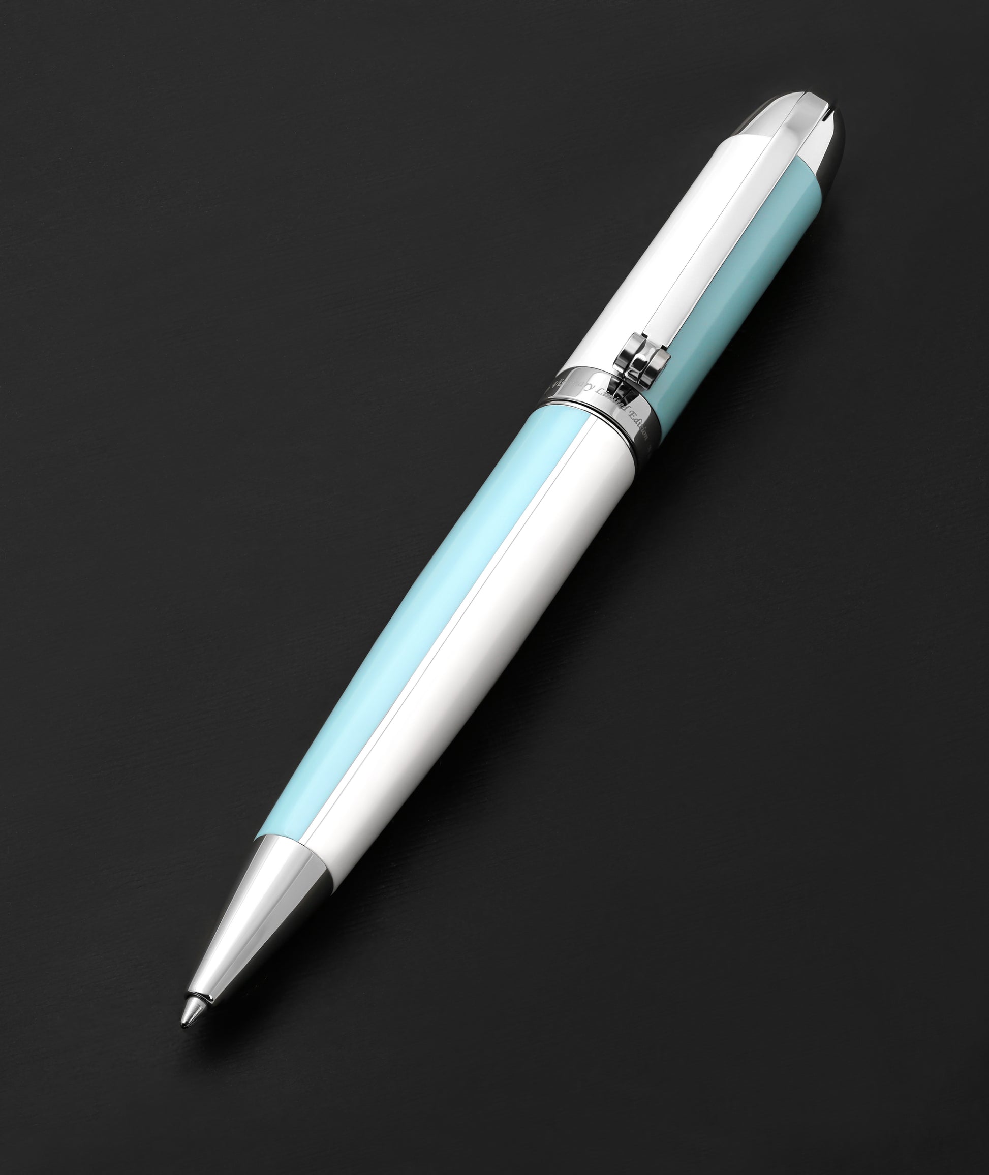Xezo - Visionary Sky Blue/White B Ballpoint pen resting on a dark background