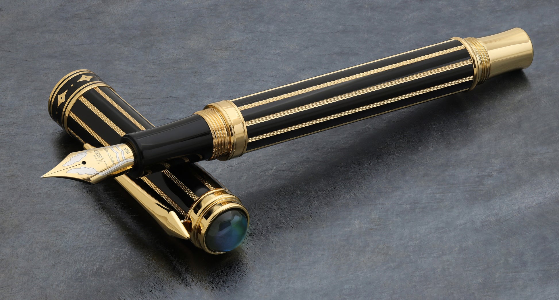 Xezo Maestro® Streamliner Labradorite EF pen and cap, pen and cap displayed on a textured dark gray surface.