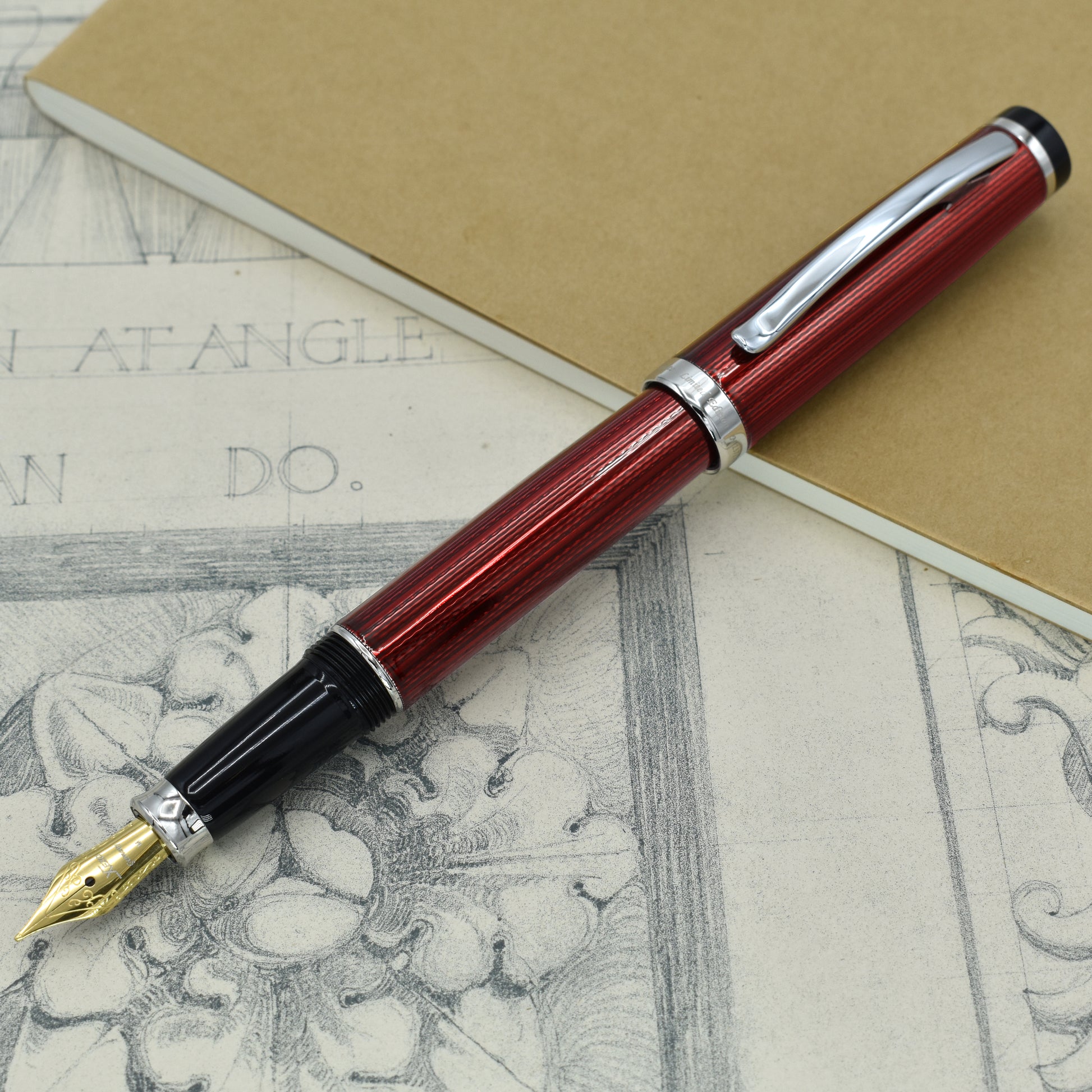 Incognito Burgundy FM Fountain pen with antique architectural sketches and a notebook