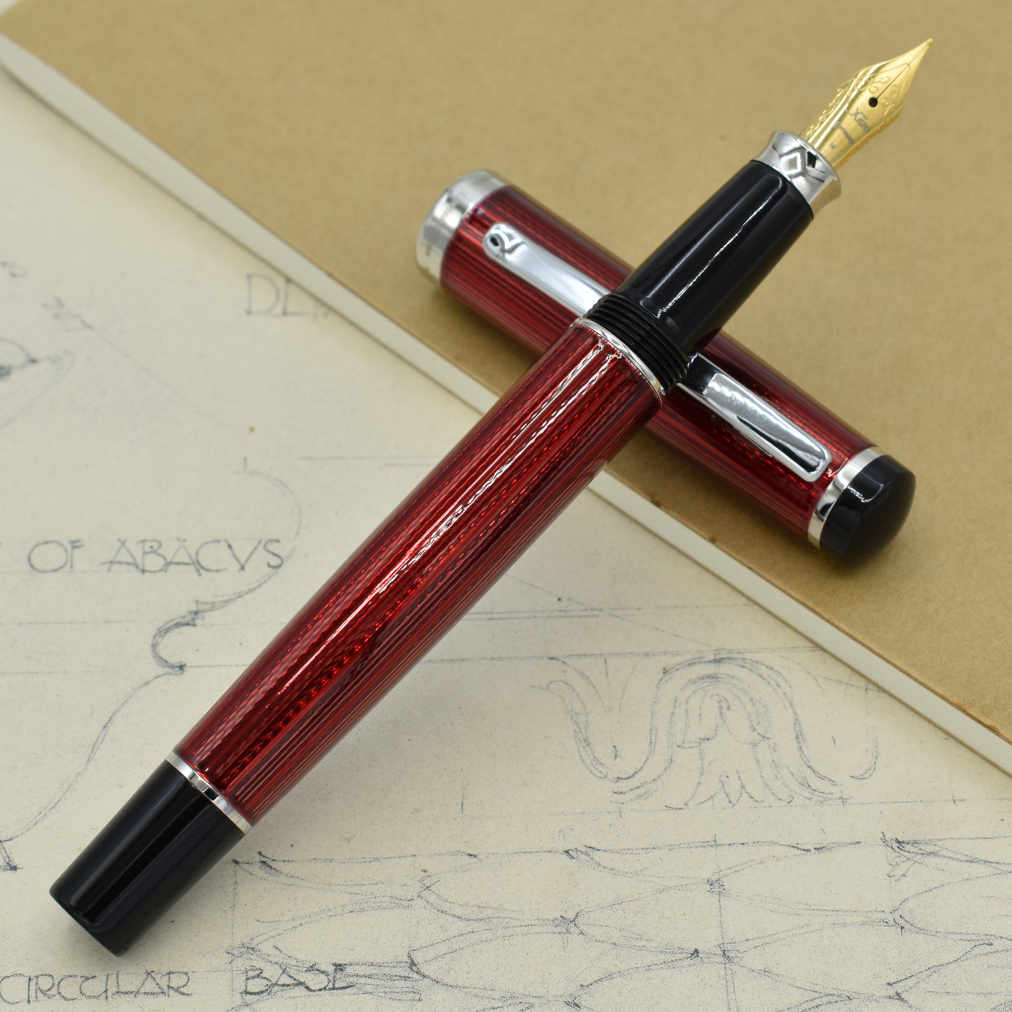 Incognito Burgundy FM Fountain pen with antique architectural sketches and a notebook