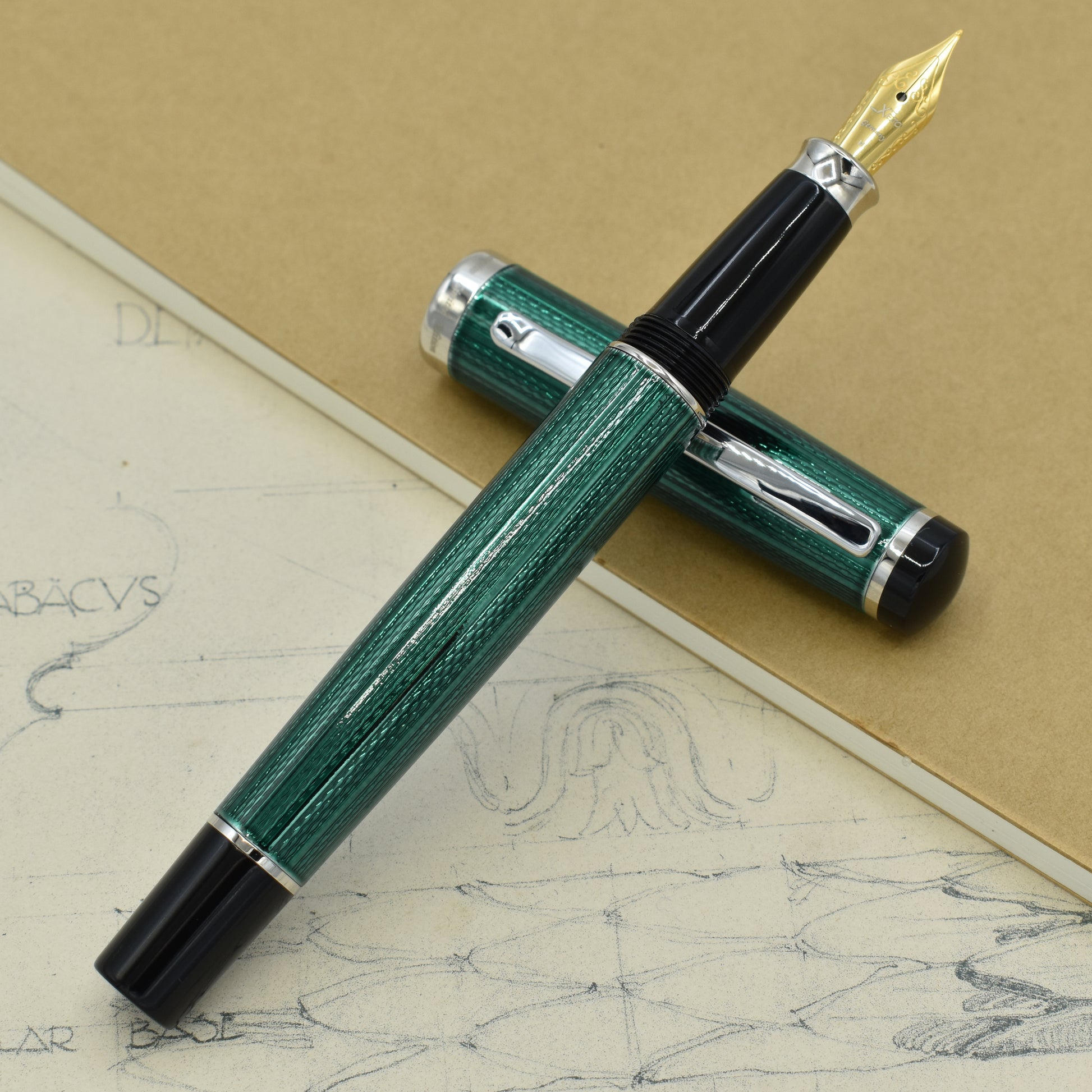 Incognito Forest FM Fountain pen with antique architectural sketches and a notebook