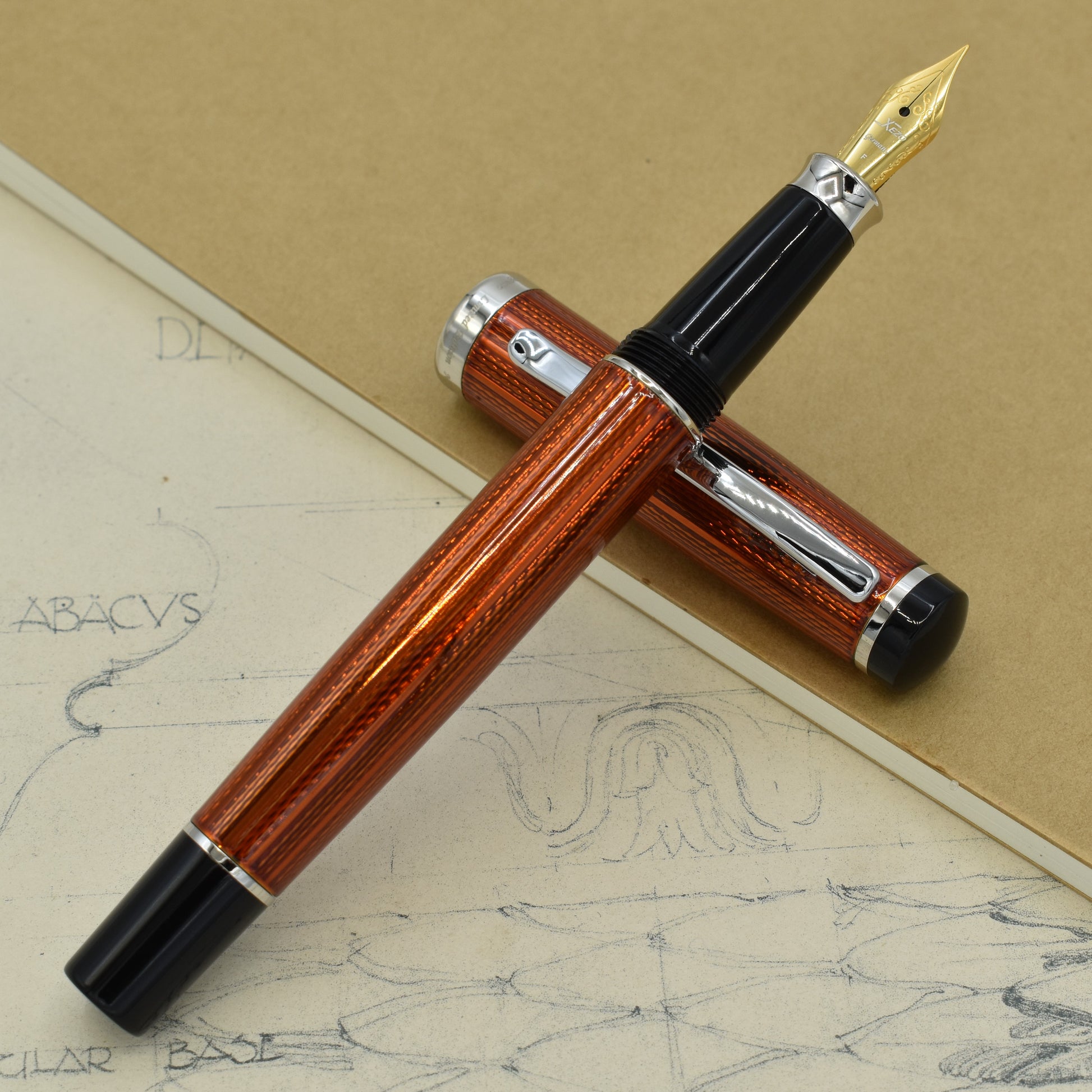 Incognito Sunstone F Fountain pen with antique architectural sketches and a notebook