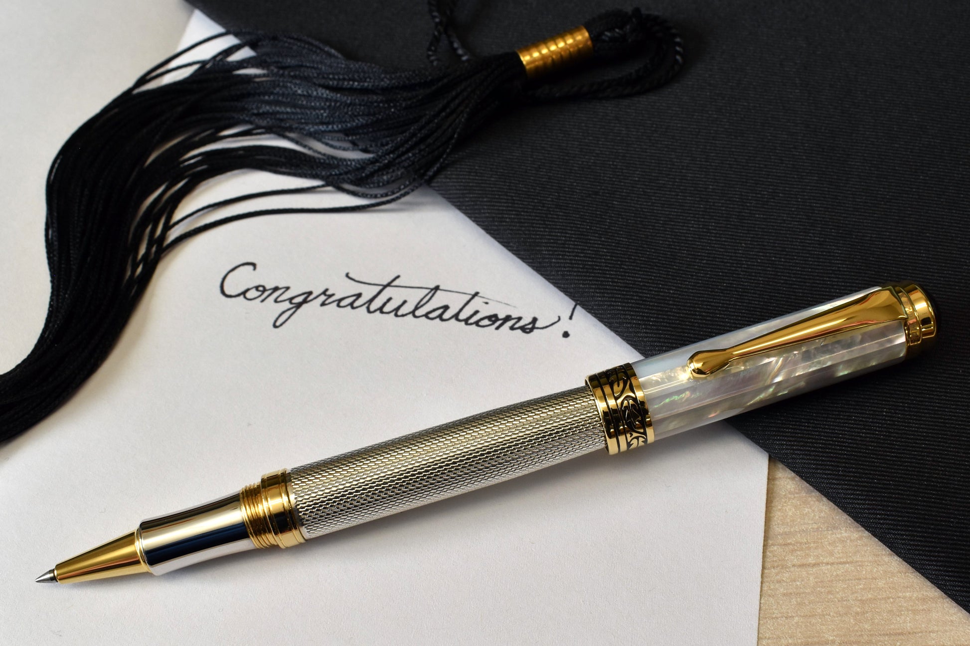 Maestro 925 White MOP R Rollerball pen with a graduation and a note that reads "Congratulations!"