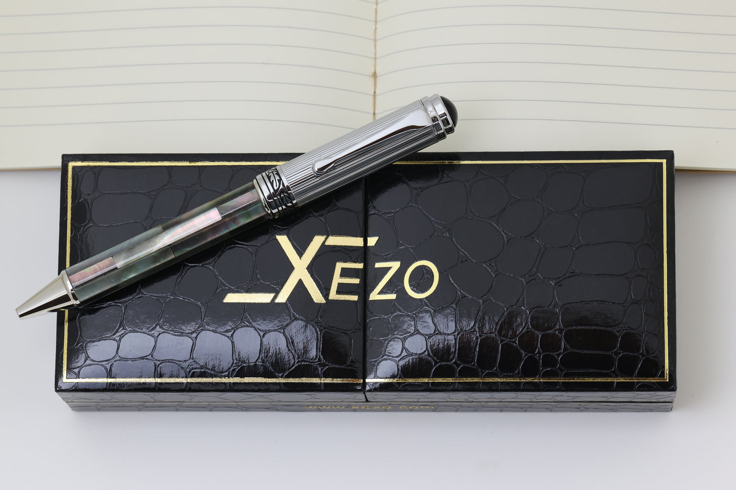 Xezo - Top view of the Maestro Black MOP Chrome B Ballpoint pen resting on its gift box
