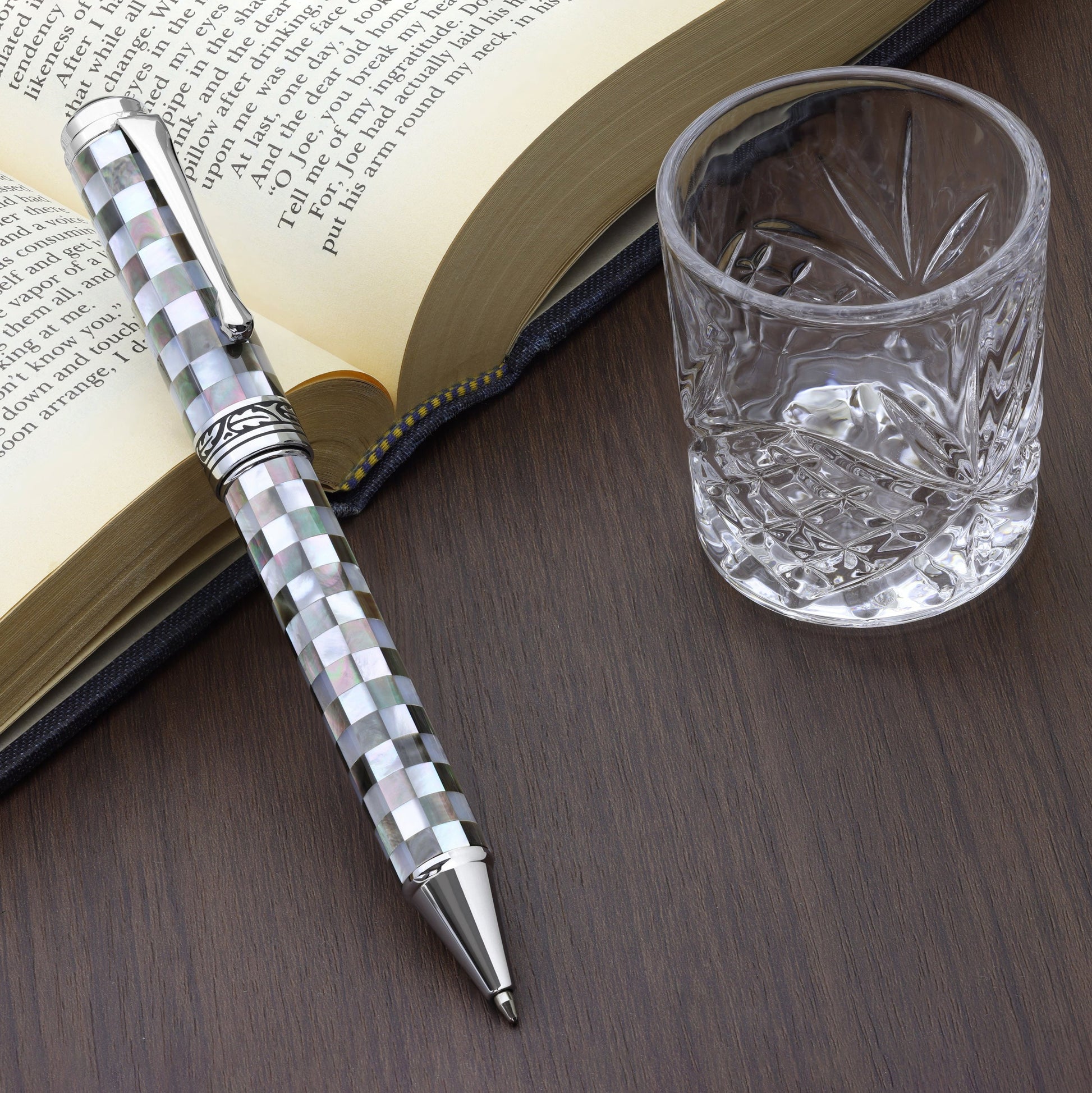 Maestro Jubilee Classic Of The Ocean B Ballpoint pen with a book and glass cup
