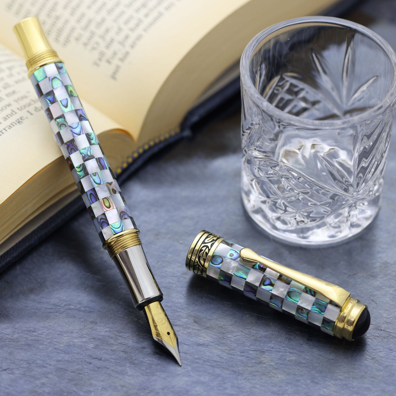 Maestro Jubilee Classic Of The Ocean FG Rollerball pen with a book and glass cup