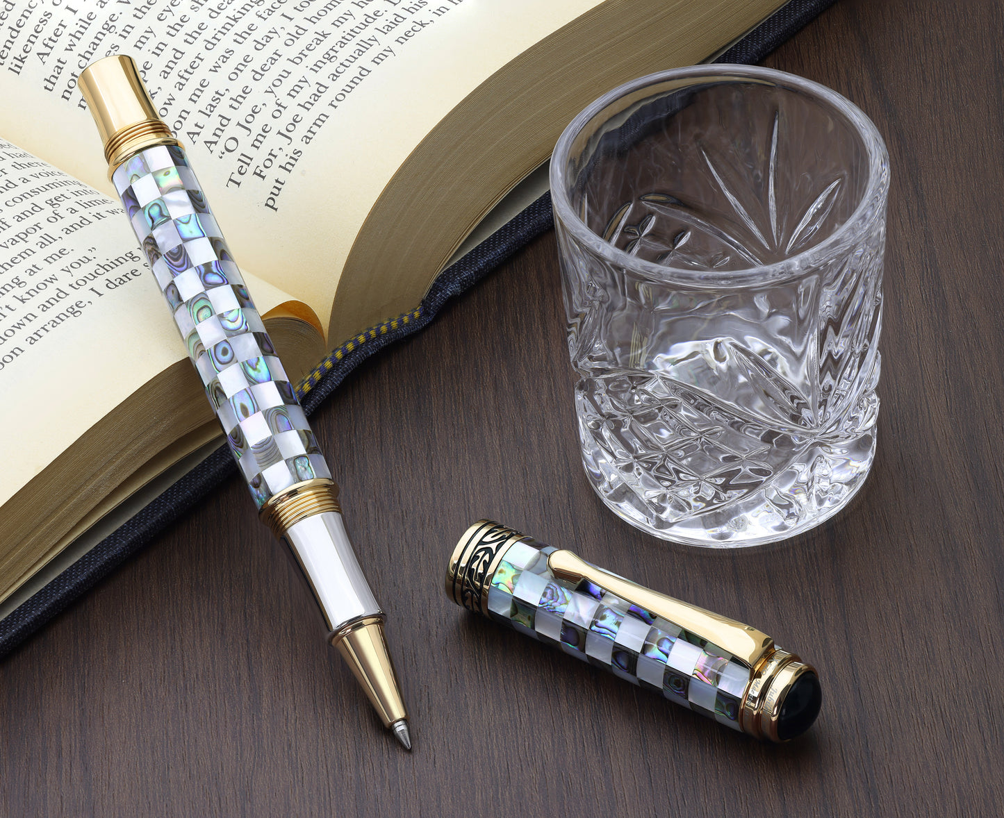 Maestro Jubilee Classic Of The Ocean R Rollerball pen with a book and glass cup