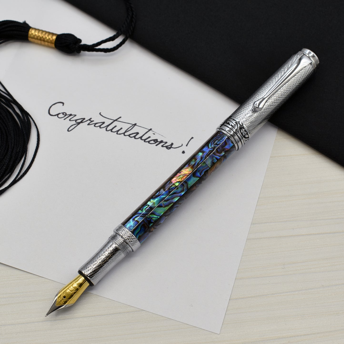 Maestro Paua Abalone Chrome F Fountain pen with a graduation and a note that reads "Congratulations!"