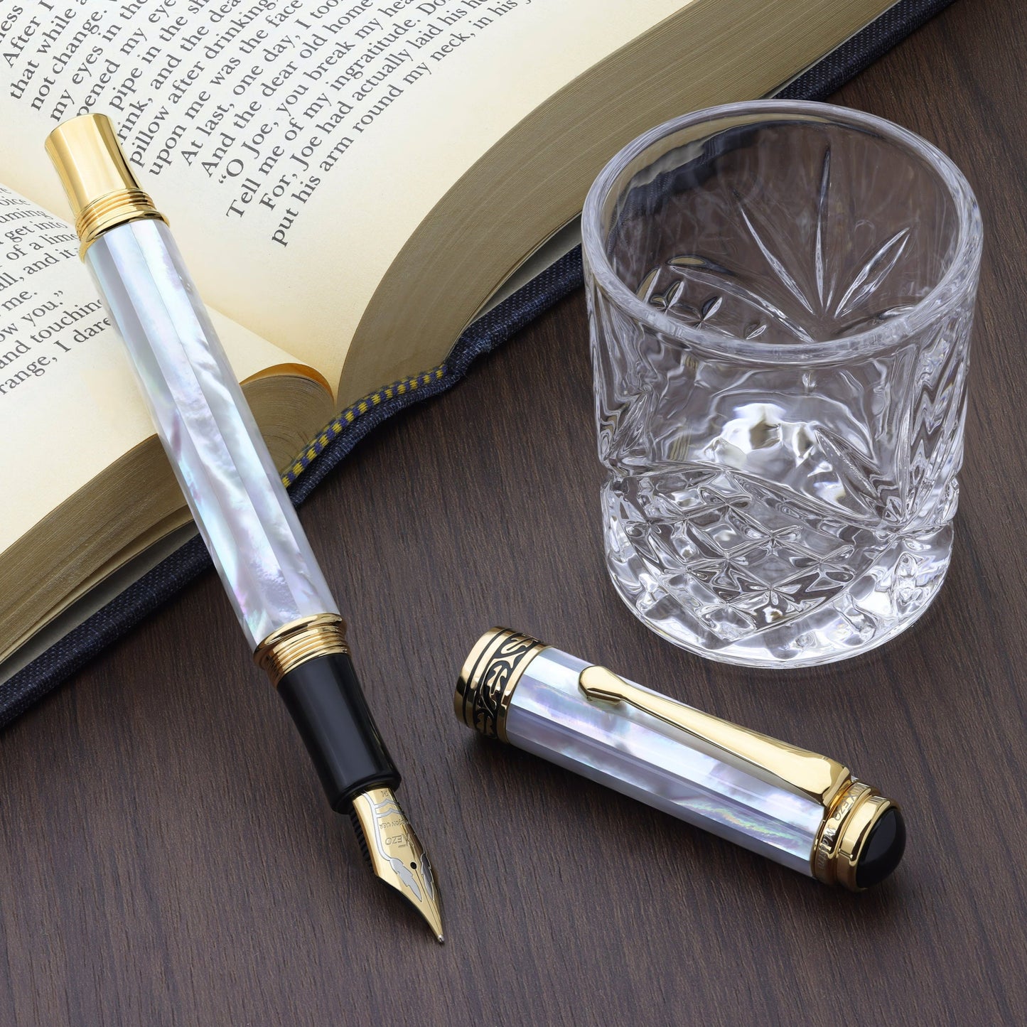 Maestro White MOP FM-2 Fountain pen with a book and glass cup