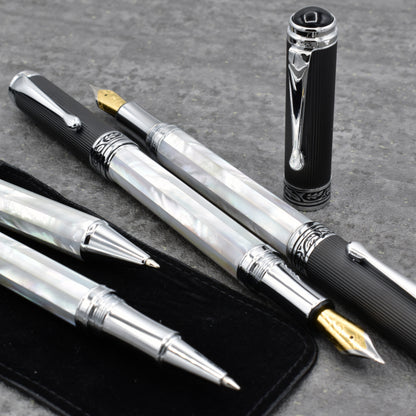 Collection of Xezo Maestro White MOP PVD pens and cap standing up next to them