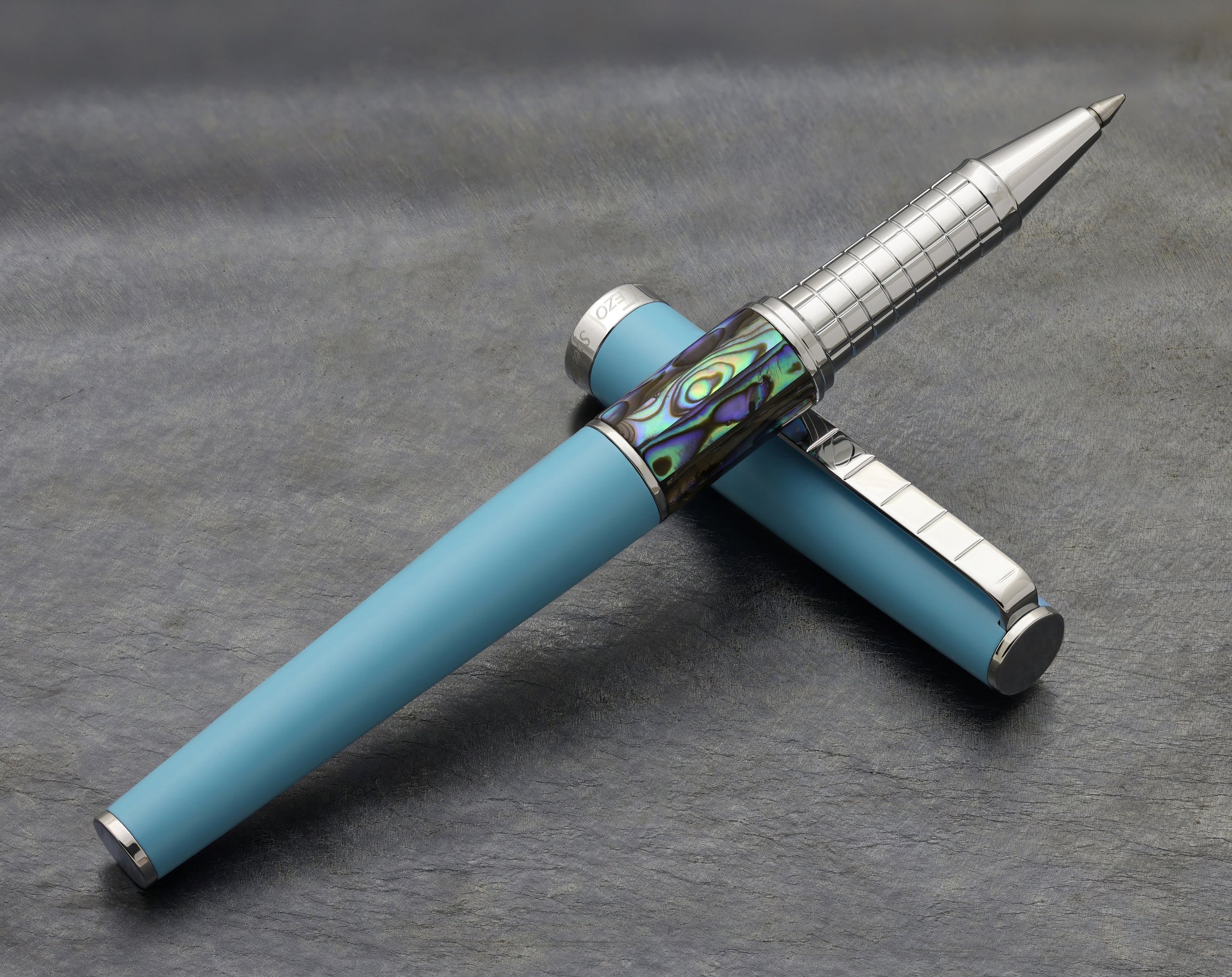 Speed Master Sky Blue R-AC Rollerball pen on a dark background