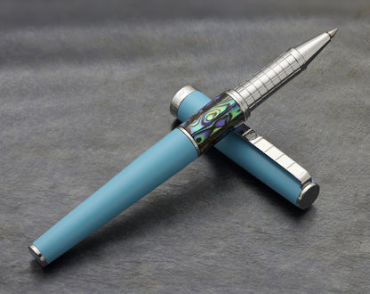 Speed Master Sky Blue R-AC Rollerball pen on a dark background