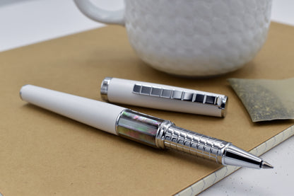 Speed Master White R-BC Rollerball pen next to a mug