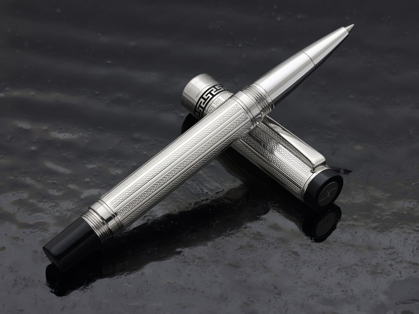 Tribune 925 Sterling Silver R Rollerball pen on a dark background