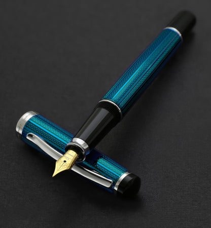 Xezo - Incognito Blue F-1 fountain pen resting on cap