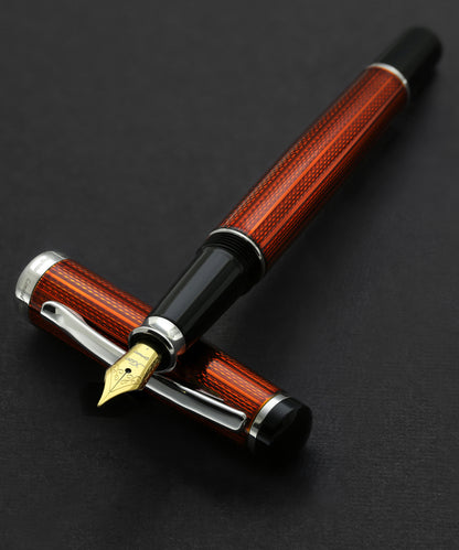 Xezo - Incognito Sunstone F fountain pen resting on its cap