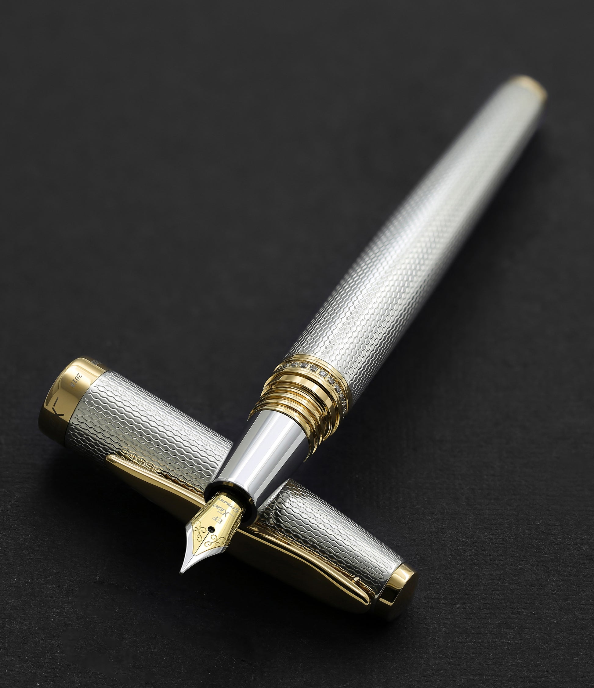 Xezo - Maestro 925 Sterling Silver EF fountain pen resting on its cap