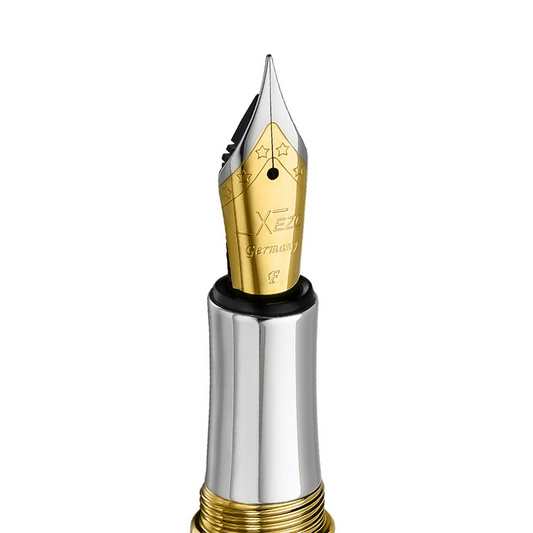 Xezo – Angled view of the front of a Fine Fountain Nib – with gold-plated body, stainless steel tines, and platinum-plated grip - Compatible with Maestro fountain pens. The body of the nib has star patterns.