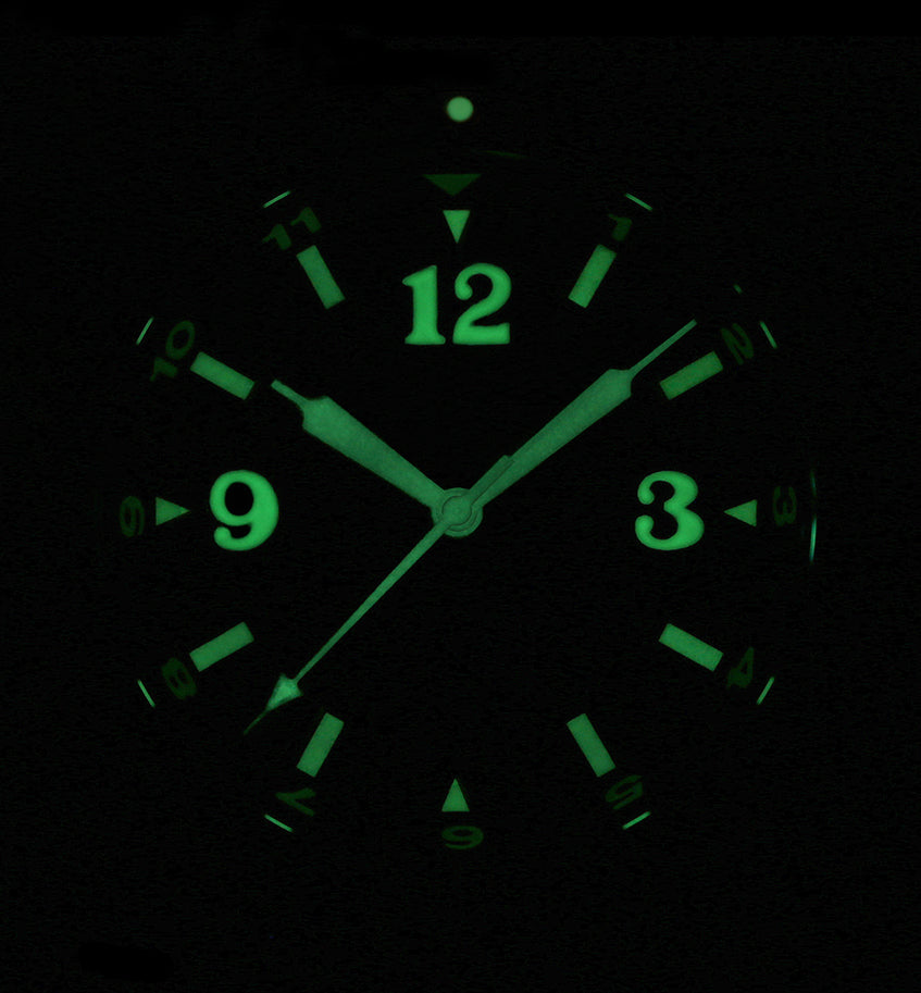 Xezo - Front view of the Air Commando D45-L watch in dark displaying the luminescent numerals