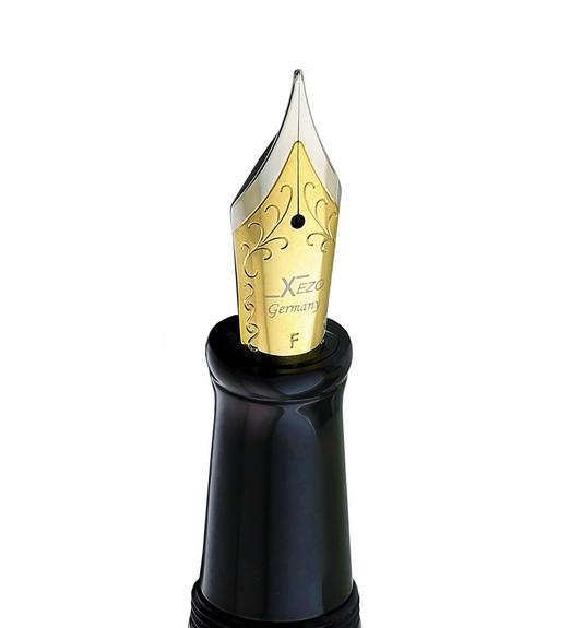 Xezo - Angled view of the front of a Fine Fountain Nib - with gold-plated body, stainless steel tines and black grip - Compatible with Maestro LeGrand fountain pens. The body of the nib has motif patterns.