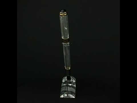 White mother-of-pearl fountain pen standing on a turning fountain stand