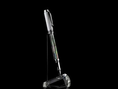 A Maestro Black MOP Chrome R rollerball pen standing on a turning pen stand