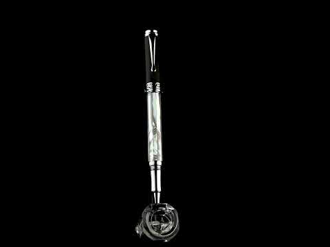 Maestro White MOP PVD R rollerball pen standing on a rotating stand
