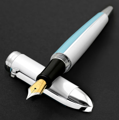 Xezo - Visionary Sky Blue/White FM fountain pen resting on its cap