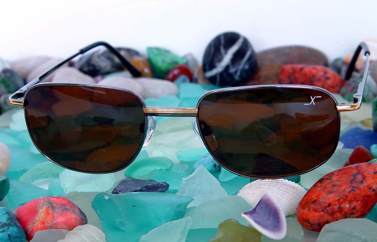 Xezo - Front view of a pair of Airacobra 180 sunglasses on colorful stones